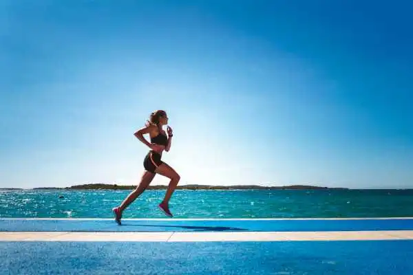 Woman running showing strong leg muscle Basildon